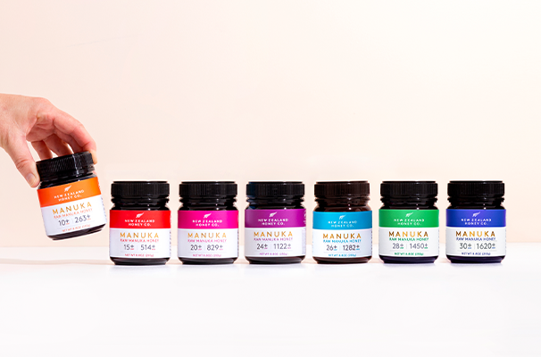 A hand reaching for a jar among colorful paint containers.