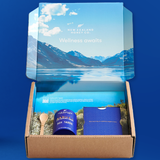 New Zealand Honey Co. wellness gift box with the lid printed with an alpine New Zealand landscape, containing a Manuka Honey jar and accessories